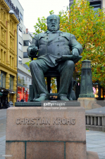 Statue of Christian Krohg on Karl Johans gate, Oslo, Norway.The statue is located to the junction of Karl Johans Gate and Lille Grensen. Christian Krohg, was a Norwegian naturalist painter, illustrator, author and journalist.