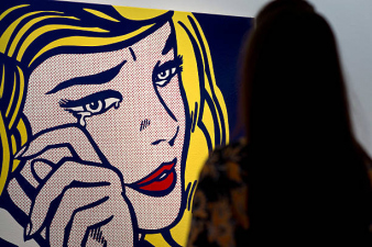 LONDON, ENGLAND - OCTOBER 09:  A guest views 'Crying Girl' by artist Roy Lichtenstein during the preview ahead of the artist's muse: a curated evening sale at Christie's New York on October 9, 2015 in London, England. The impressionist, modern, post-war and contemporary works will be on show to the public between October 10 and October 17 and includes Amedeo Modigliani's 'Nu couche' which is estimated to sell for 100 USD million. The sale also showcases pieces by artists including Lucian Freud, Paul Cezanne, Peter Doig, Pablo Picasso, Alberto Giacometti, Amedeo Modigliani and Roy Lichtenstein.  (Photo by Ben Pruchnie/Getty Images)